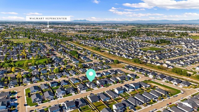 aerial overview of property's location featuring mountains and nearby suburban area