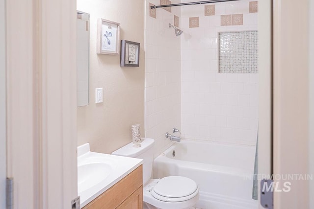 bathroom featuring toilet, vanity, and shower / bathtub combination