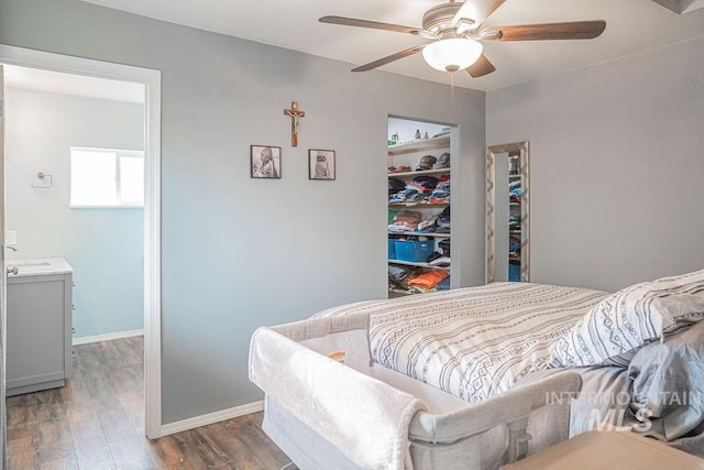 bedroom featuring wood finished floors, baseboards, and ceiling fan