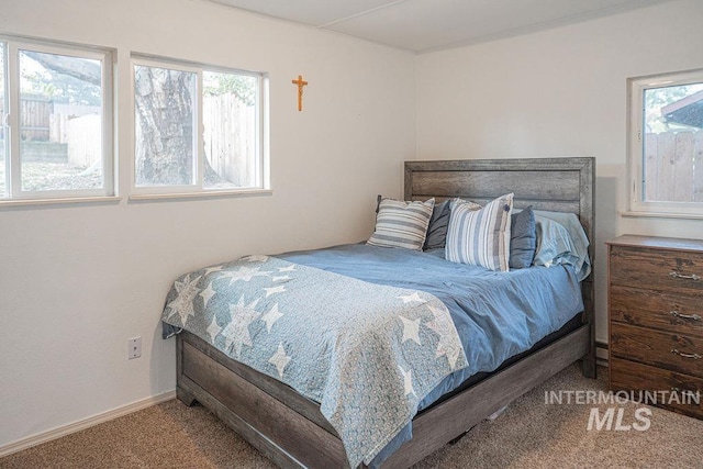 carpeted bedroom featuring baseboards