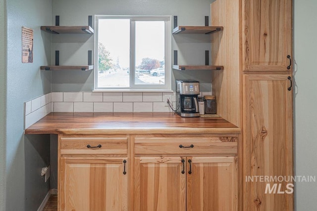 kitchen featuring open shelves, decorative backsplash, wooden counters, and light brown cabinetry