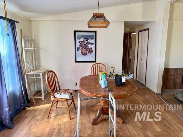 dining area with wood finished floors and crown molding