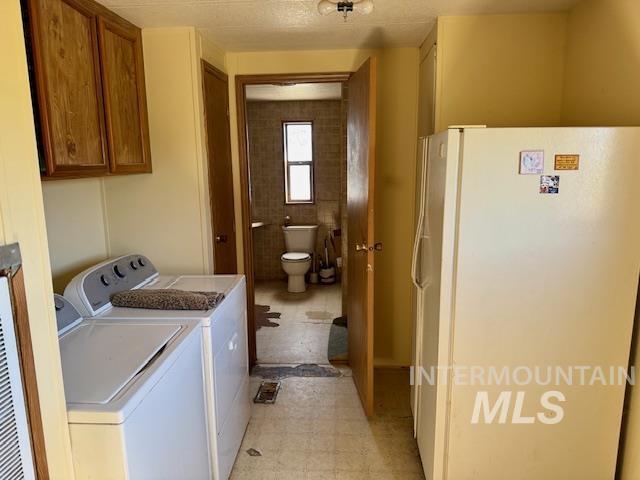 laundry room with separate washer and dryer and light floors