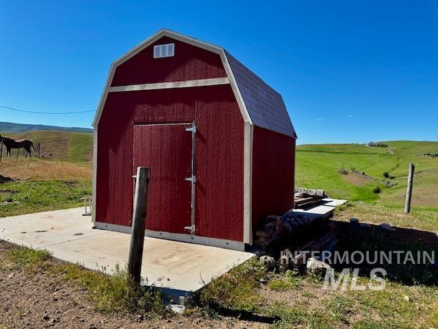 view of barn with a rural view