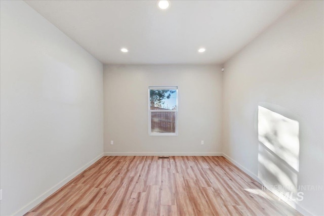 spare room with light hardwood / wood-style flooring