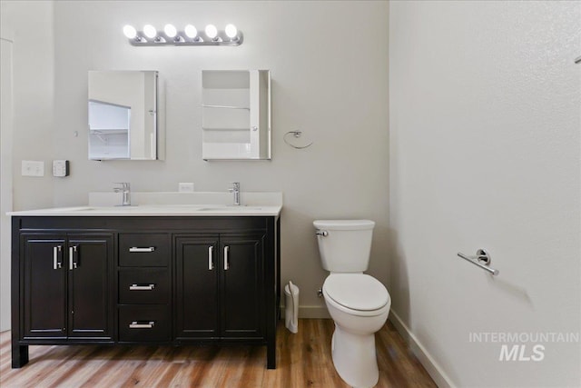 bathroom featuring vanity, hardwood / wood-style floors, and toilet