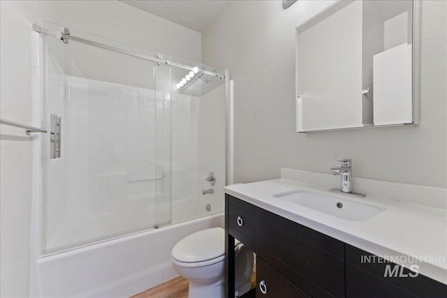 full bathroom featuring toilet, vanity, shower / bath combination with glass door, and hardwood / wood-style floors