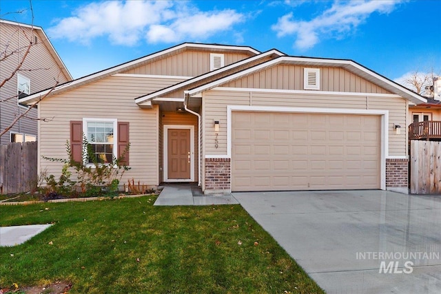 view of front of home with a garage and a front lawn