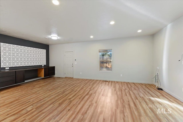 unfurnished living room featuring light wood-type flooring