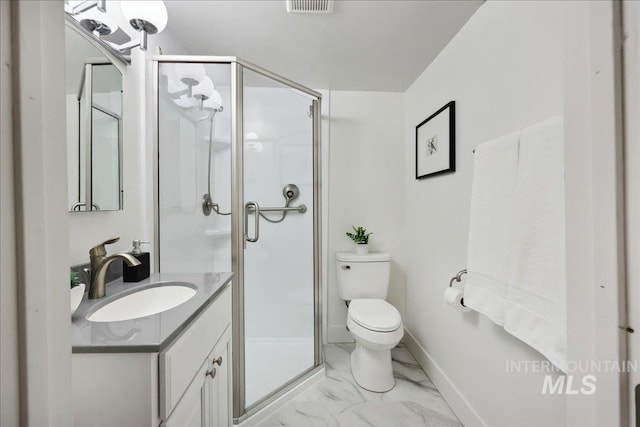 full bath featuring toilet, vanity, a shower stall, and marble finish floors