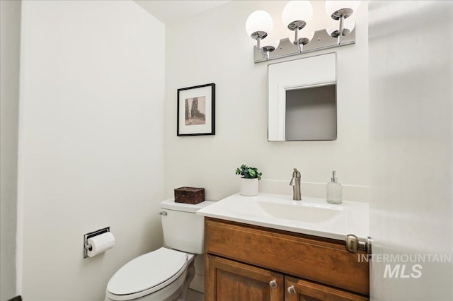 bathroom with toilet and vanity