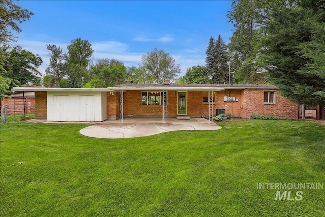 back of house featuring a patio and brick siding