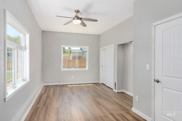 3716 W Palouse St, Boise, ID 83705 - unfurnished bedroom with multiple windows, wood finished floors, and baseboards