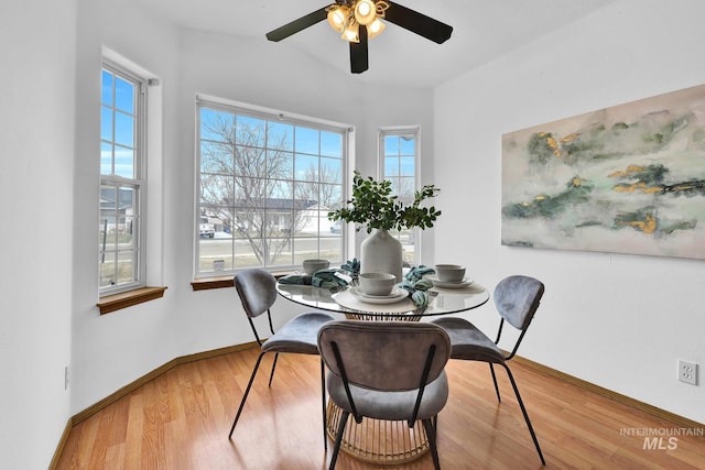 dining area featuring ceiling fan, baseboards, and wood finished floors