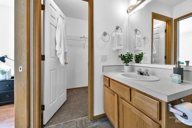 bathroom with baseboards and vanity