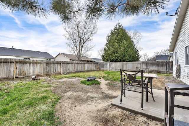 view of yard with a patio area, a fenced backyard, and an outdoor fire pit