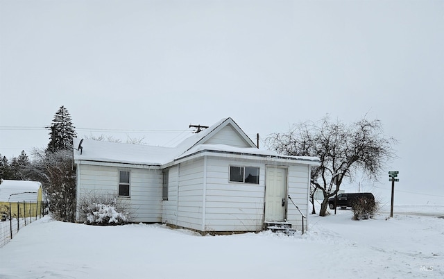 view of snow covered rear of property