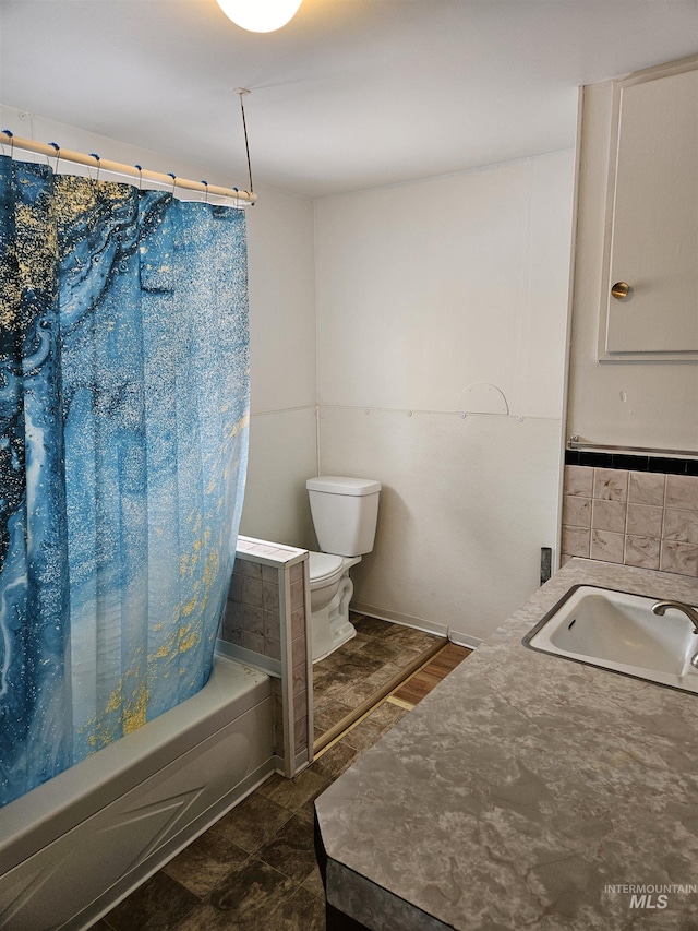 full bathroom featuring shower / tub combo with curtain, sink, and toilet