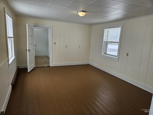 spare room with dark hardwood / wood-style floors