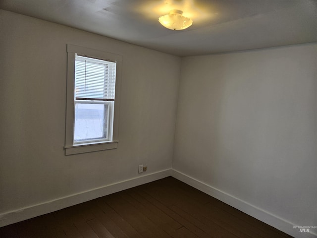 spare room with dark hardwood / wood-style flooring