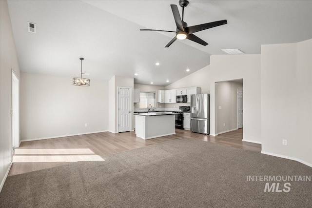11177 Champlain Pl Unit 9, Caldwell, ID 83605 - kitchen featuring stainless steel fridge with ice dispenser, electric range oven, open floor plan, white cabinets, and carpet floors