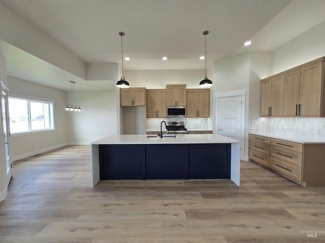 563 Full Moon Way, Twin Falls, ID 83301 - kitchen with stainless steel appliances, decorative backsplash, recessed lighting, light countertops, and an island with sink