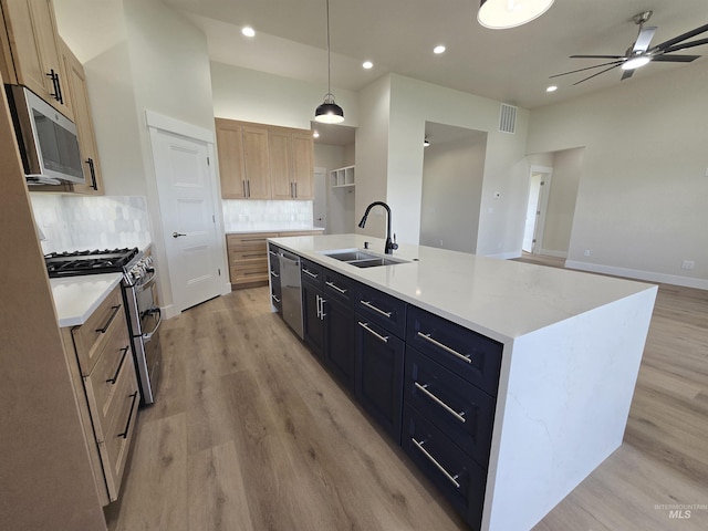 563 Full Moon Way, Twin Falls, ID 83301 - kitchen with stainless steel appliances, light wood-style floors, ceiling fan, tasteful backsplash, and recessed lighting
