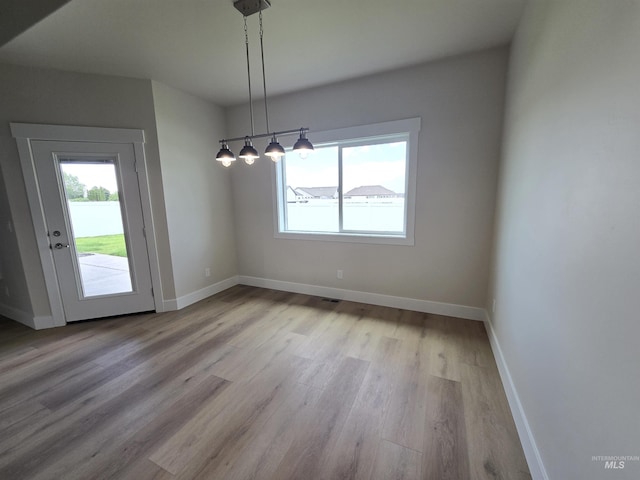 563 Full Moon Way, Twin Falls, ID 83301 - unfurnished dining area featuring healthy amount of natural light and wood finished floors