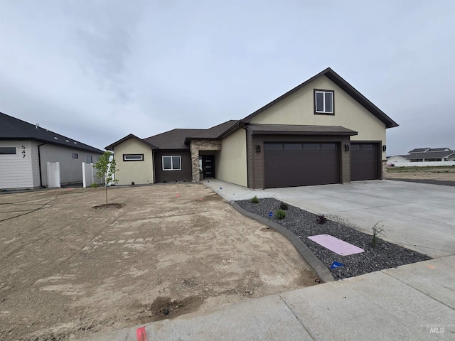 563 Full Moon Way, Twin Falls, ID 83301 - view of front facade with stucco siding, concrete driveway, and an attached garage