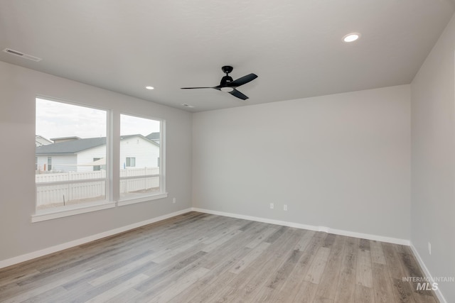 unfurnished room featuring ceiling fan and light wood-type flooring