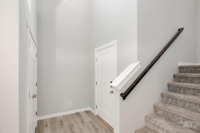 stairs with hardwood / wood-style flooring