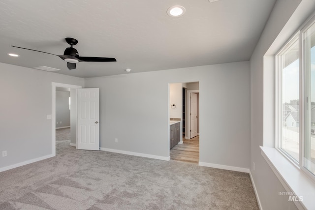 carpeted empty room featuring ceiling fan