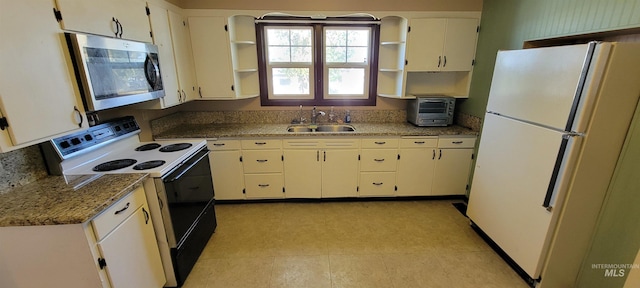 kitchen featuring light stone counters, white cabinets, sink, and white appliances