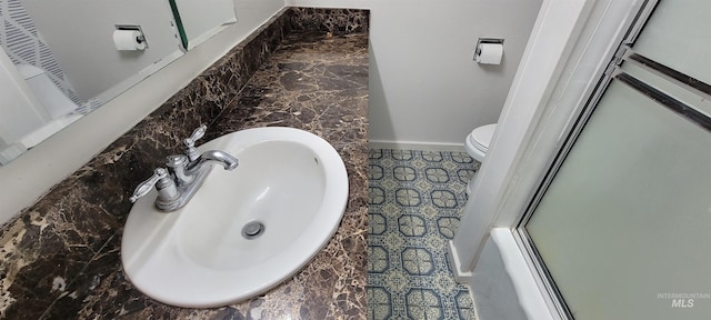 bathroom with vanity, toilet, and an enclosed shower