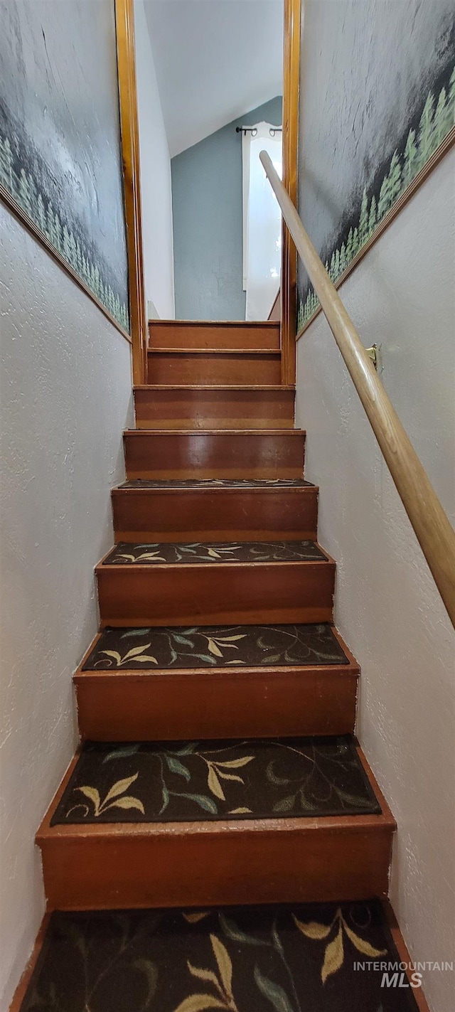 staircase featuring vaulted ceiling