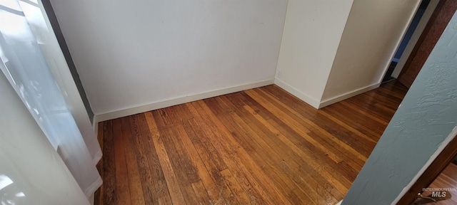 empty room featuring dark hardwood / wood-style flooring