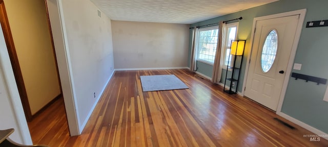 entryway featuring a textured ceiling and hardwood / wood-style floors