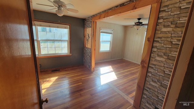 unfurnished room featuring ceiling fan and hardwood / wood-style flooring