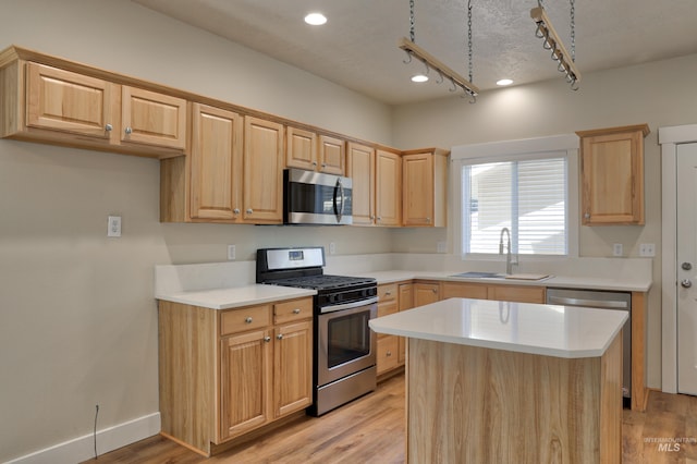1421 S Denver Ave, Boise, ID 83706 - kitchen featuring appliances with stainless steel finishes, a sink, light brown cabinetry, light countertops, and light wood-style flooring