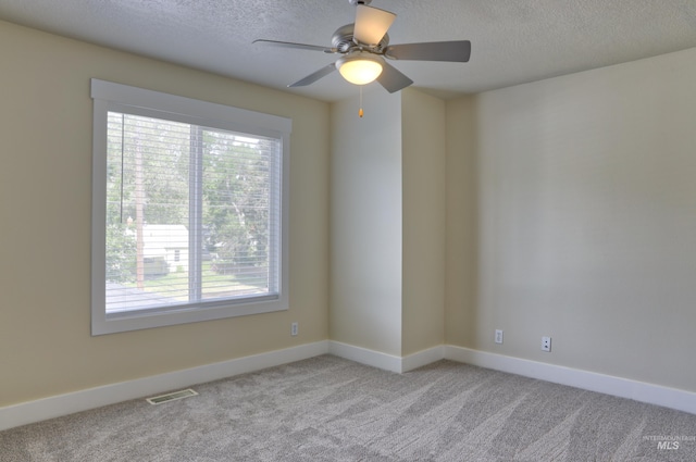 1421 S Denver Ave, Boise, ID 83706 - unfurnished room featuring healthy amount of natural light, carpet flooring, a textured ceiling, baseboards, and a ceiling fan