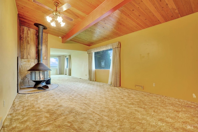 425 W 700 N, Paul, ID 83347 - unfurnished living room featuring a wood stove, carpet floors, wood ceiling, and ceiling fan