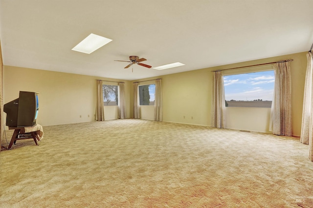 carpeted empty room featuring ceiling fan