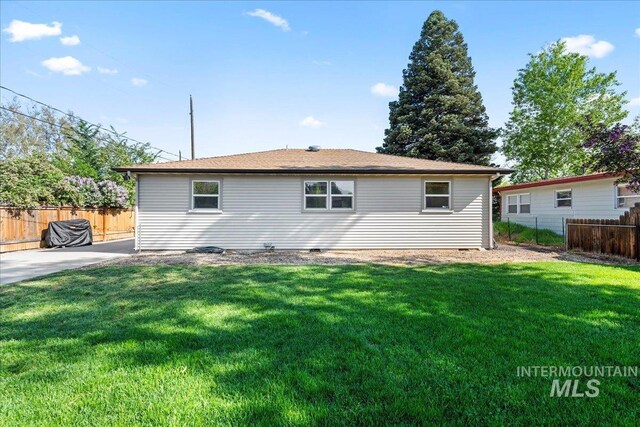 back of house with a lawn, fence, and a patio area
