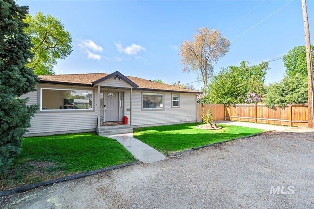 view of front facade with fence and a front lawn