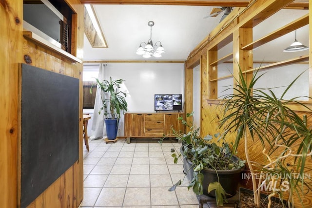interior space with light tile patterned floors, decorative light fixtures, brown cabinets, and a notable chandelier