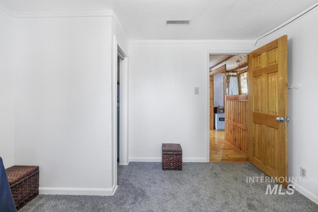 interior space featuring crown molding, baseboards, and visible vents