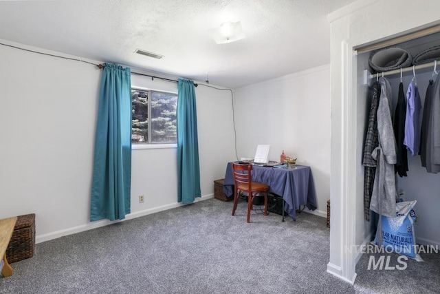 carpeted bedroom featuring a textured ceiling, visible vents, and baseboards