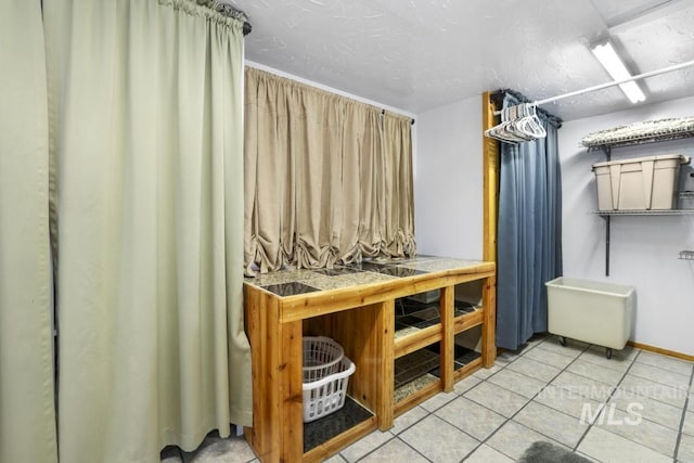 bathroom with baseboards and tile patterned flooring