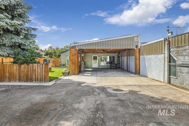garage featuring driveway and an attached carport