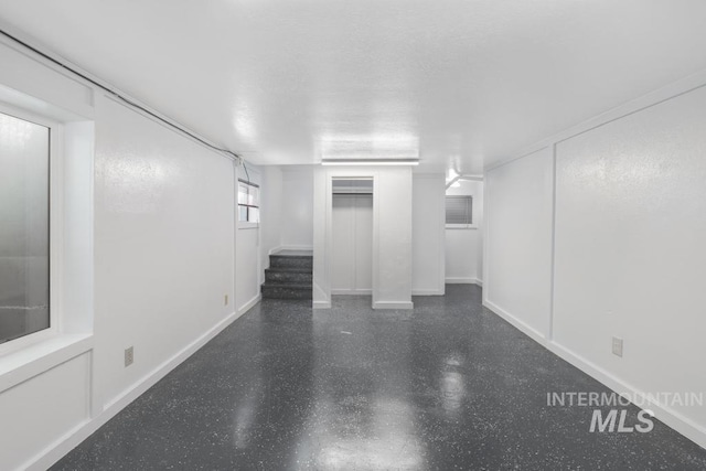 below grade area with baseboards and stairway